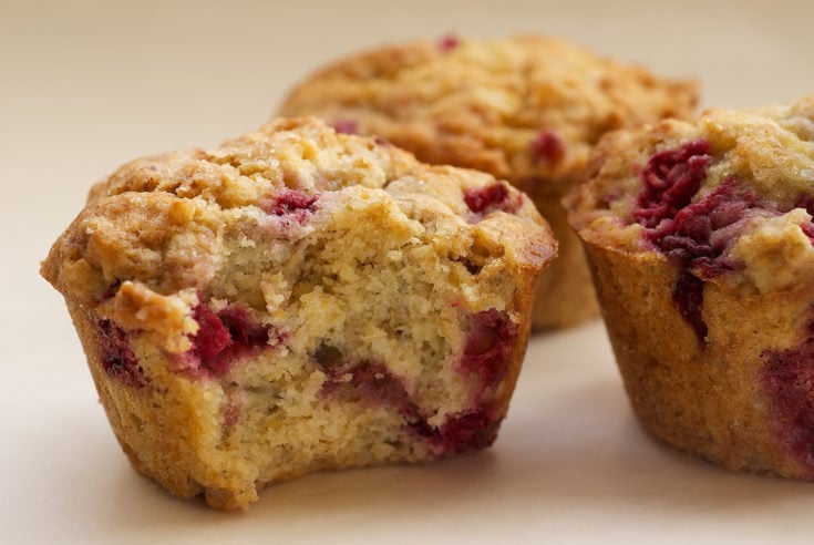 Raspberry Oat Muffins on a white surface