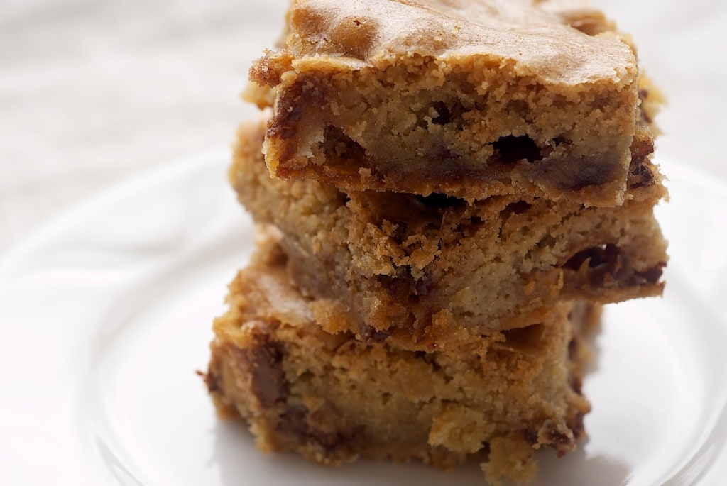 stack of Candy Bar Blondies on a white plate