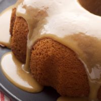 Caramel Bundt Cake on a dark gray cake plate