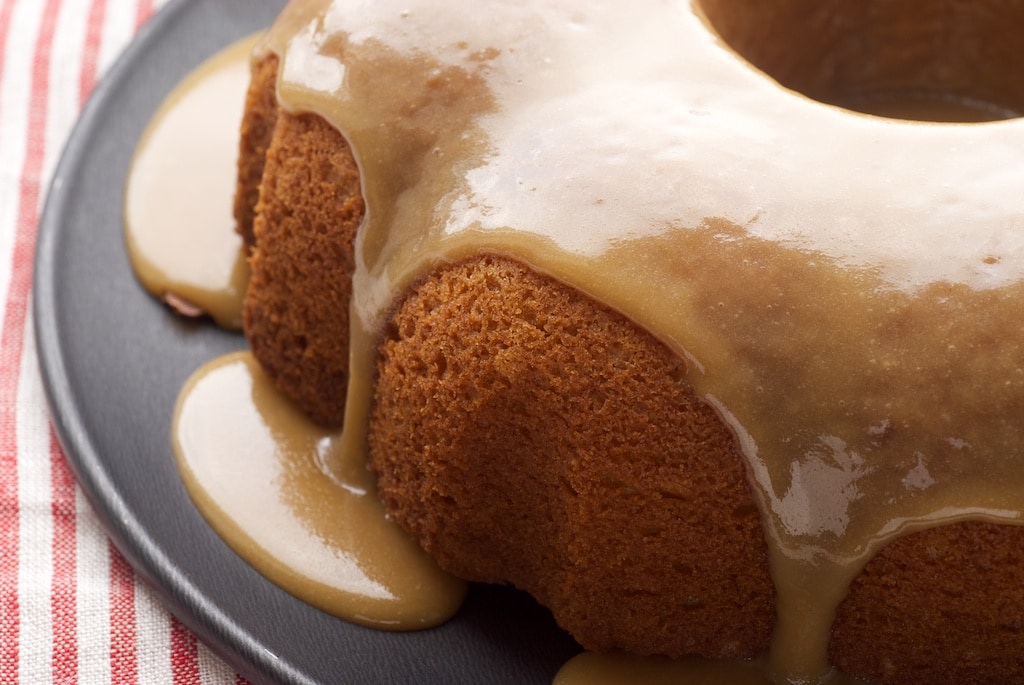 Caramel Bundt Cake on a dark gray cake plate