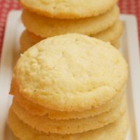 Cornmeal Cookies stacked on a white plate