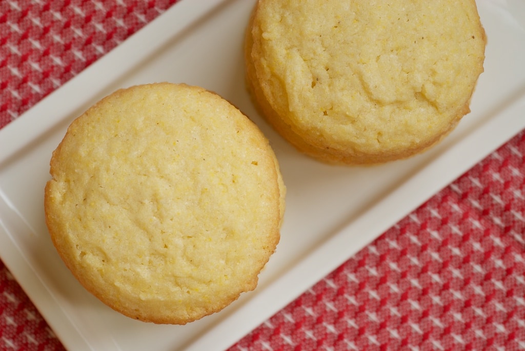 overhead view of Cornmeal Cookies stacked on a white plate