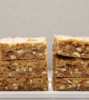 two stacks of brown butter blondies on a white plate
