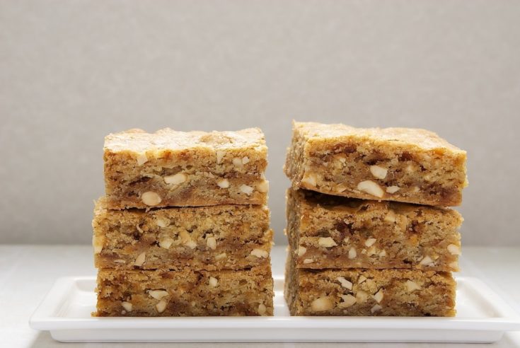 two stacks of brown butter blondies on a white plate