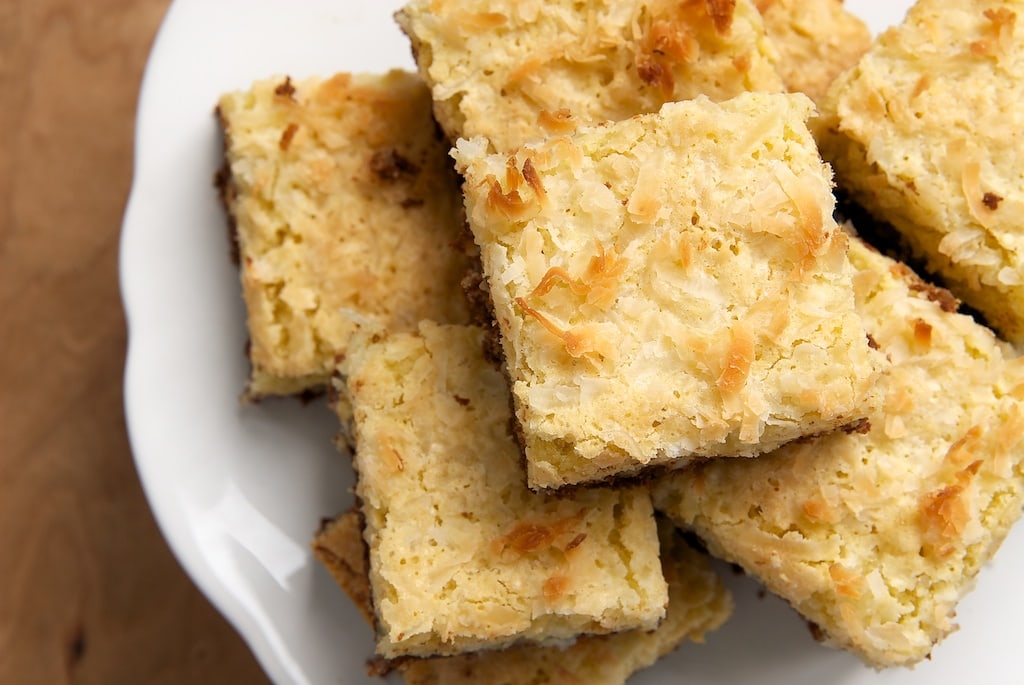 Coconut Bars with Chocolate Shortbread Crust on a white serving pedestal