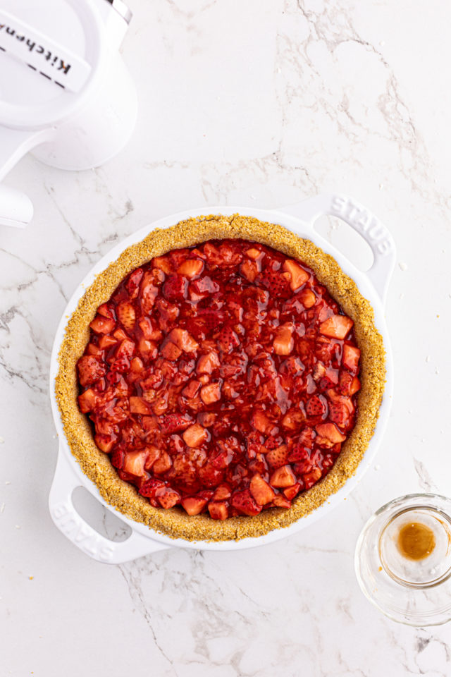 Overhead view of strawberry layer in graham cracker crust