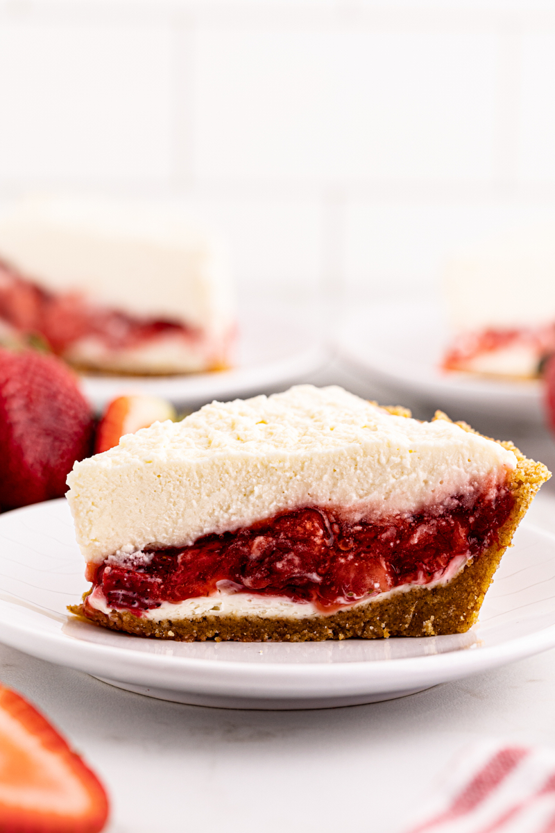 Side view of strawberry icebox pie slice on plate to show layers