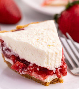 Fluffy strawberry icebox pie on plate, with tip eaten