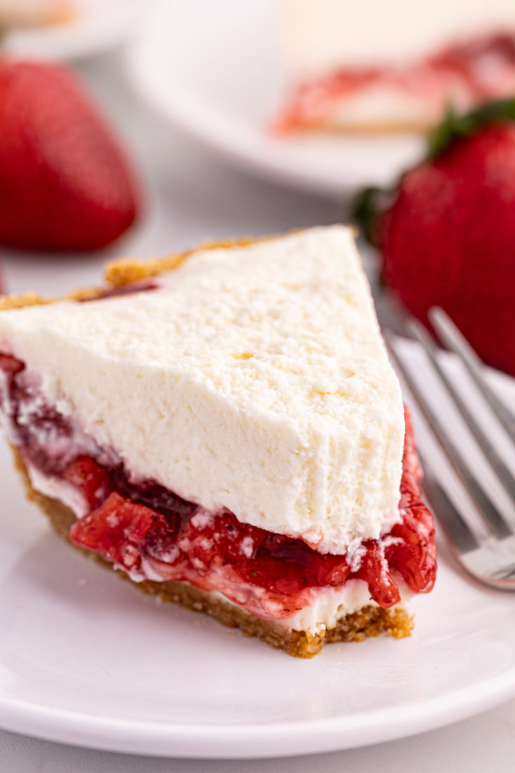 Fluffy strawberry icebox pie on plate, with tip eaten