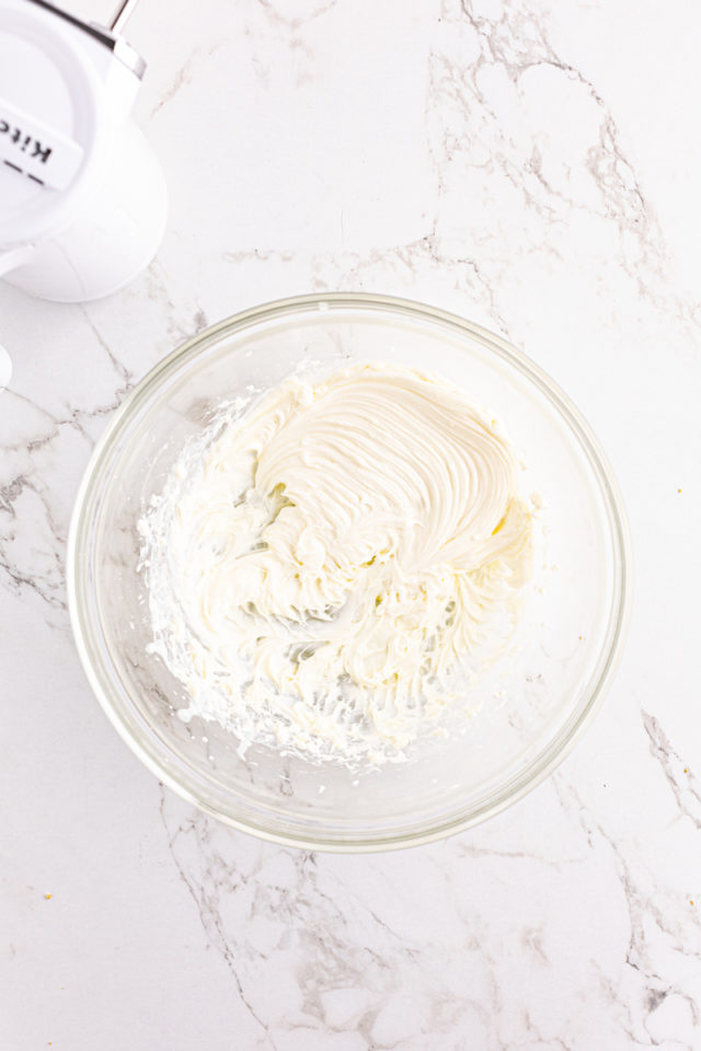 Overhead view of whipped cream cheese in mixing bowl