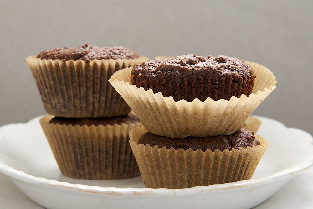 Mocha Muffins stacked on a white plate