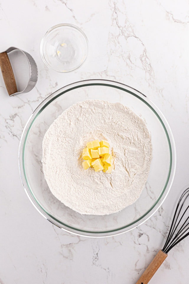 Butter cubes in bowl of dry ingredients for biscuits