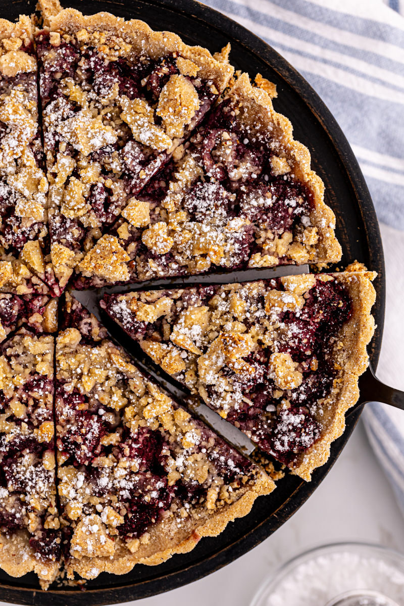Overhead view of raspberry crumb tart on round platter