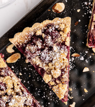 Overhead view of raspberry crumb tart slices on platter