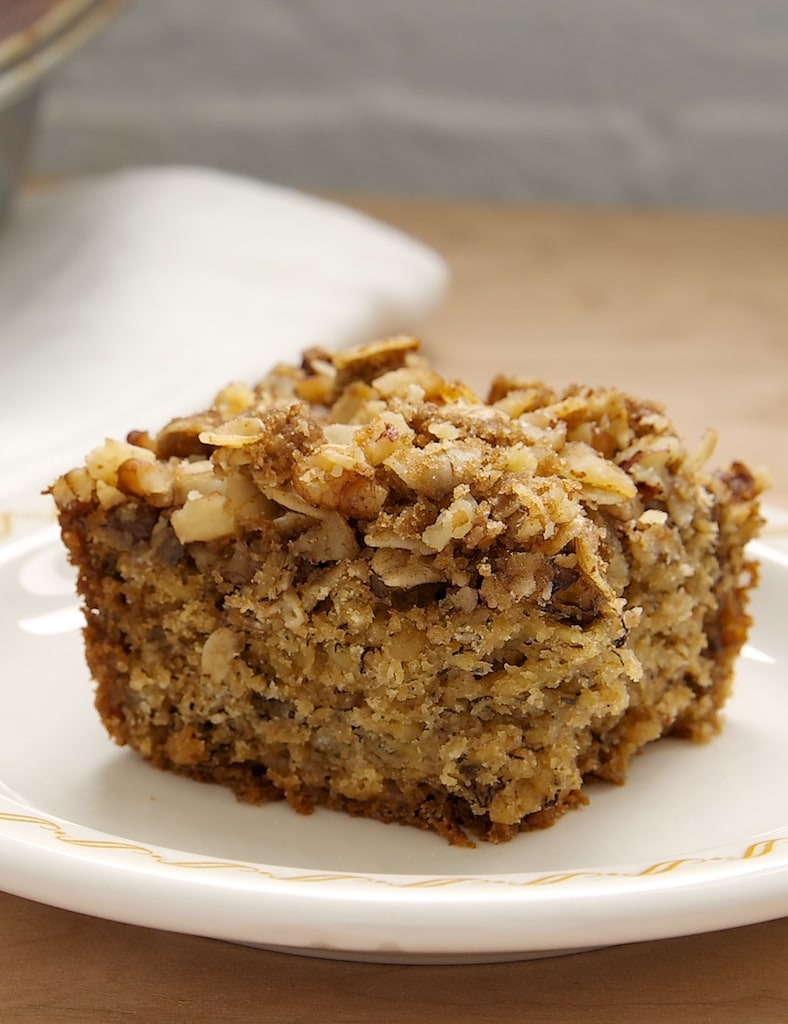 Banana Oatmeal Crumb Cake is a tasty cake that's a little bit banana bread and a little bit coffee cake. Serve this one from breakfast to dessert! - Bake or Break