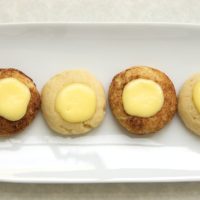 overhead view of Cheesecake Thumbprint Cookies on a white plate