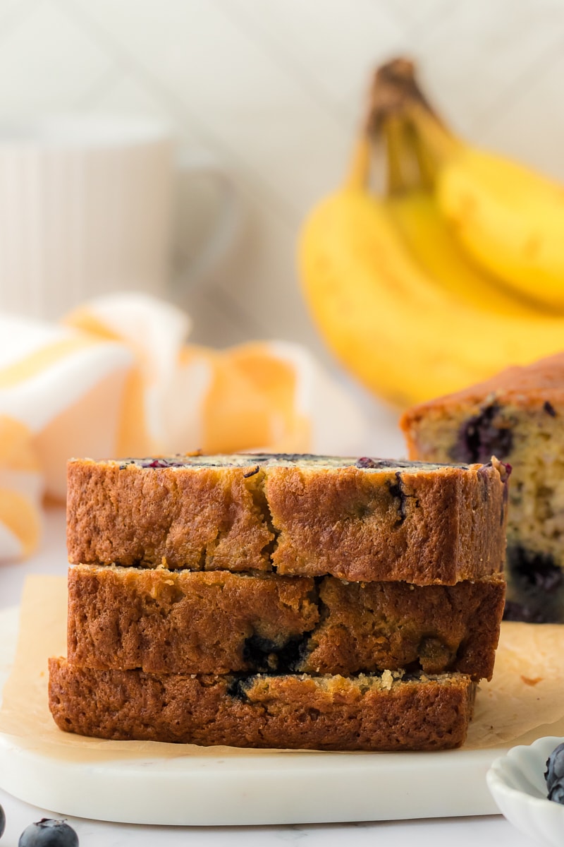 Stack of blueberry quick bread slices.