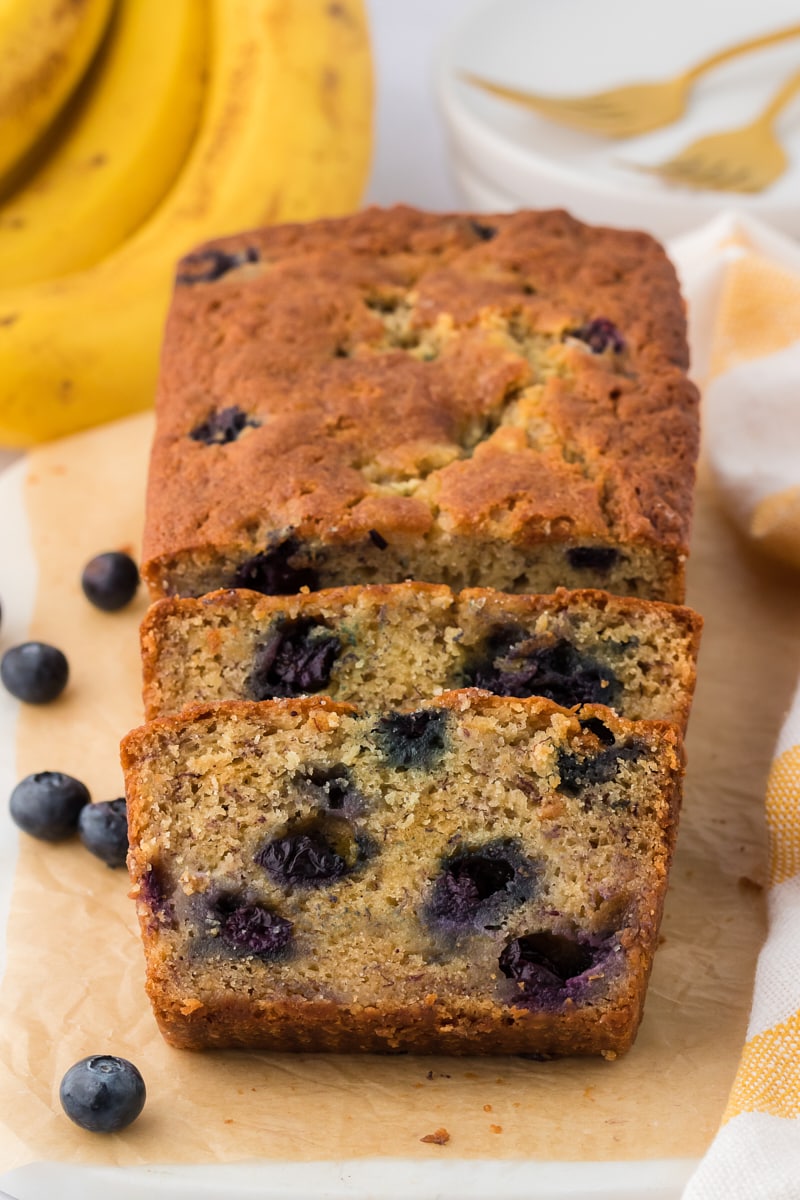 Banana bread slices leaning against a loaf.