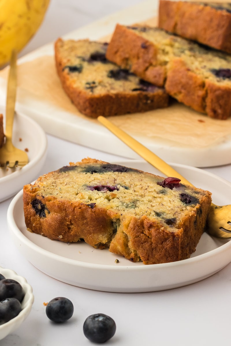 Slice of blueberry banana bread on a plate.