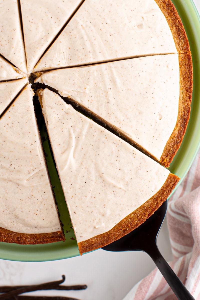 Pulling slice of vanilla bean cake from cake stand