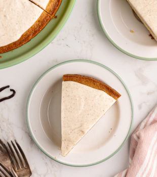 Overhead view of vanilla bean cake slices on plates and cake stand