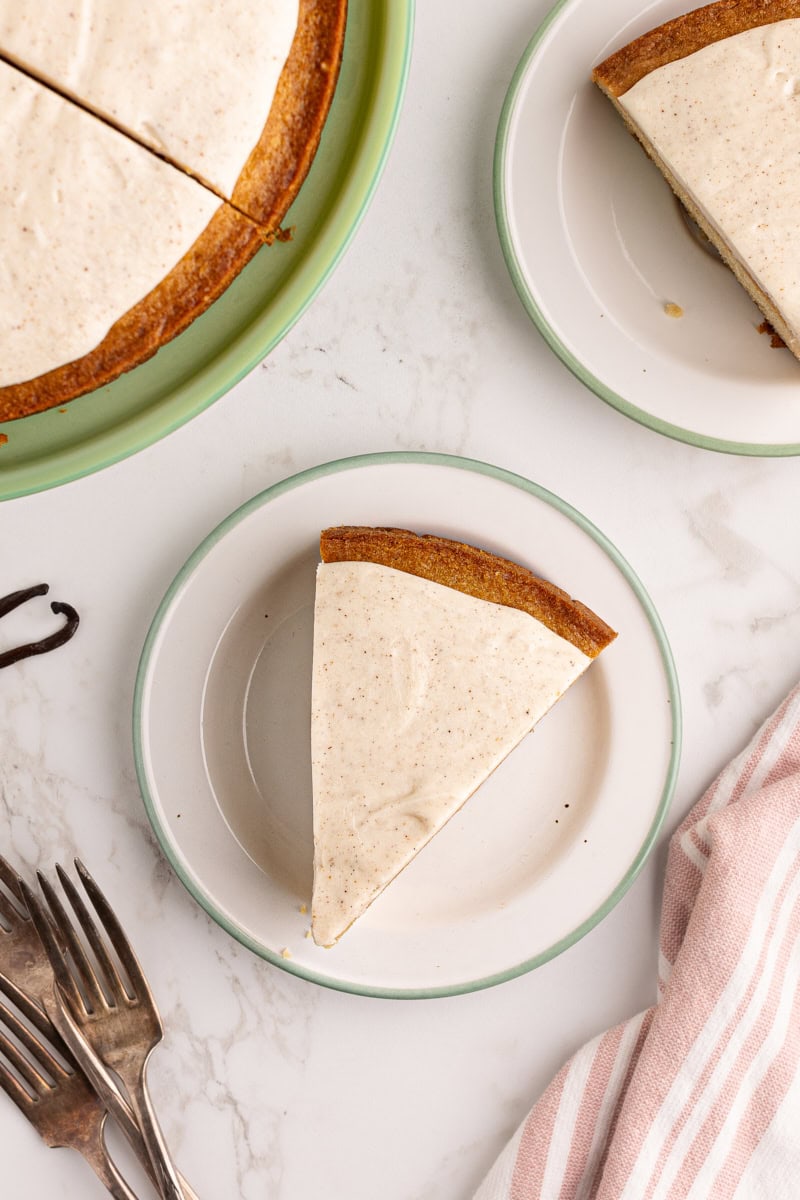 Overhead view of vanilla bean cake slices on plates and cake stand