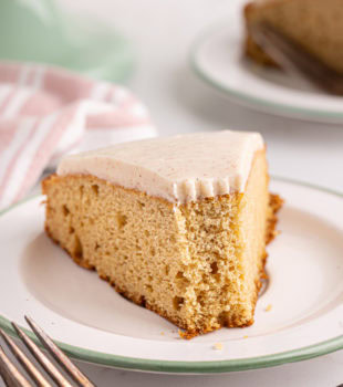 Slice of vanilla bean cake on plate with tip eaten