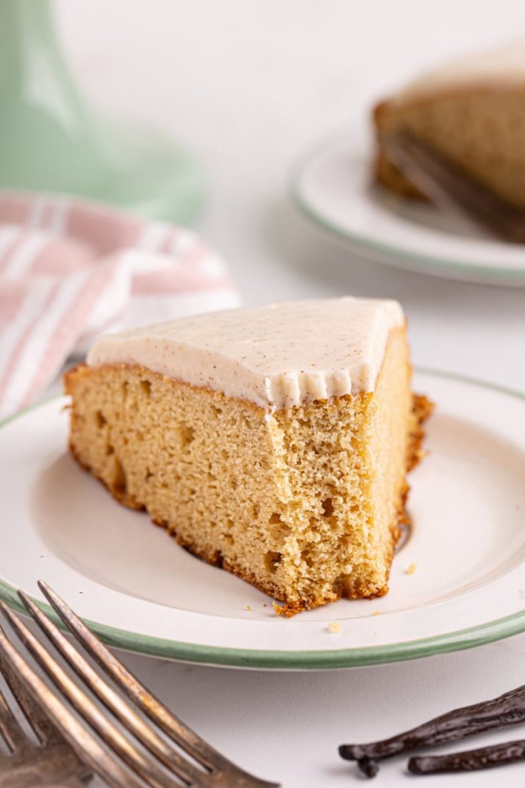 Slice of vanilla bean cake on plate with tip eaten