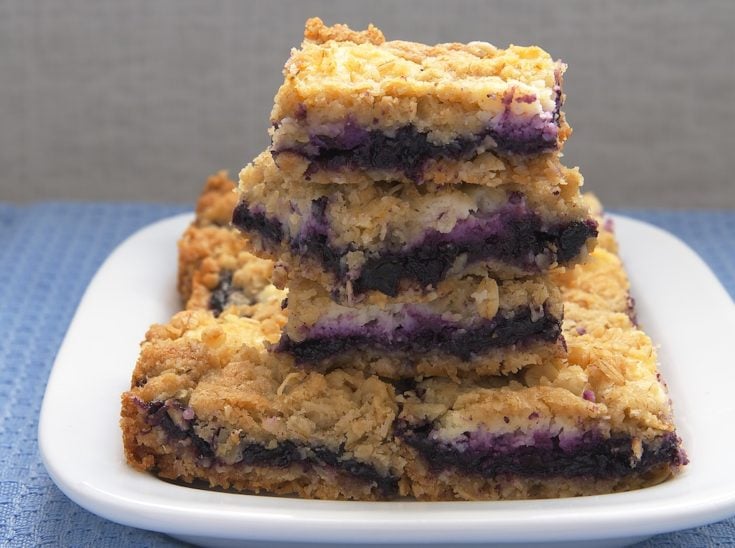 Blueberry Jam-Cream Cheese Bars stacked on a white plate