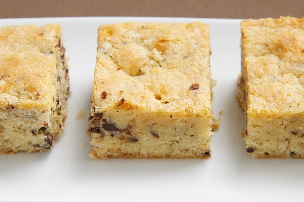 side view of White Chocolate Brownies on a white tray