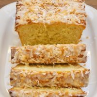 Sliced Coconut Buttermilk Pound Cake on white plate