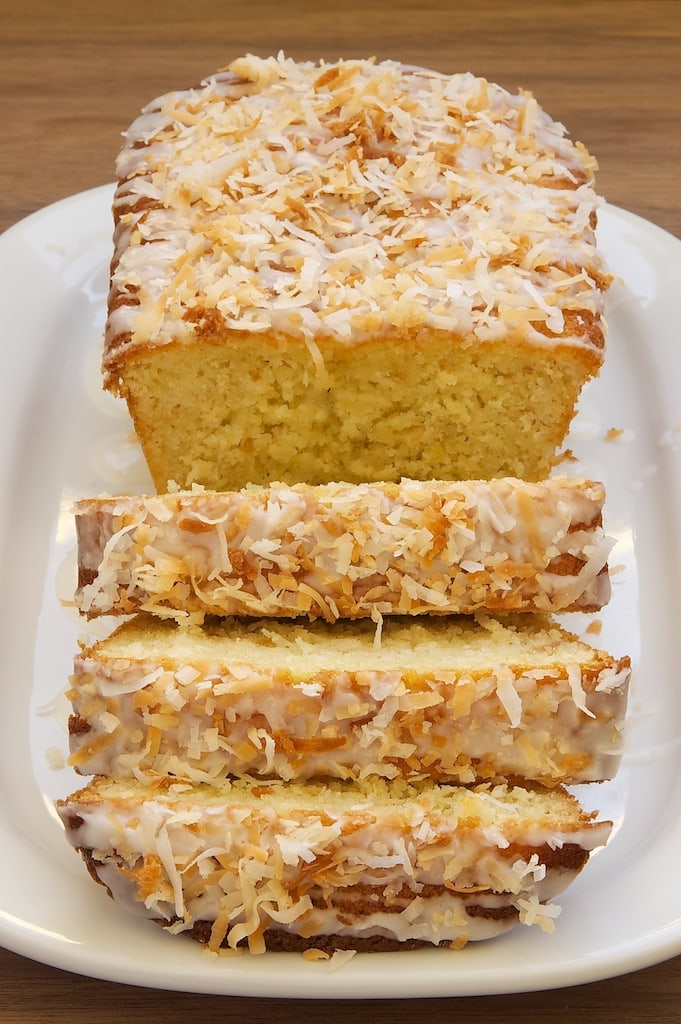 sliced Coconut Buttermilk Pound Cake topped with a sweet glaze and toasted coconut