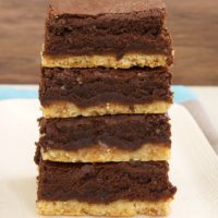 stack of Caramel Popcorn Shortbread Brownies on a white plate