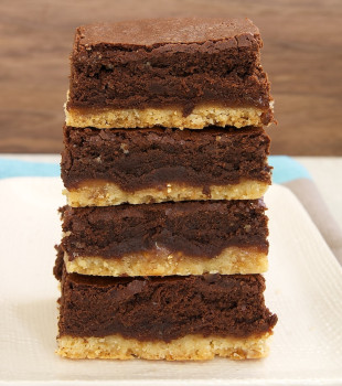 stack of Caramel Popcorn Shortbread Brownies on a white plate