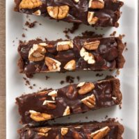 overhead view of slices of Chocolate Pecan Tart on a long white tray