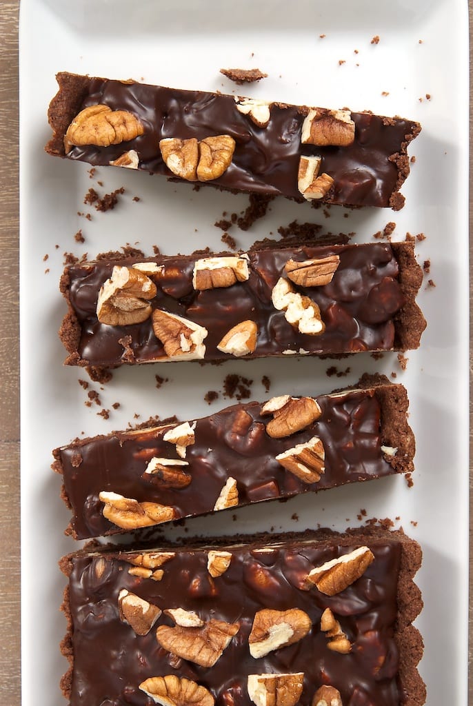 overhead view of slices of Chocolate Pecan Tart on a long white tray