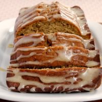 sliced Caramelized Banana Bread with Brown Butter Glaze on a white serving plate