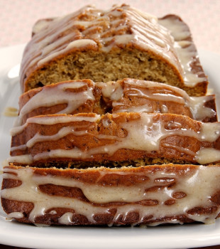 sliced Caramelized Banana Bread with Brown Butter Glaze on a white serving plate