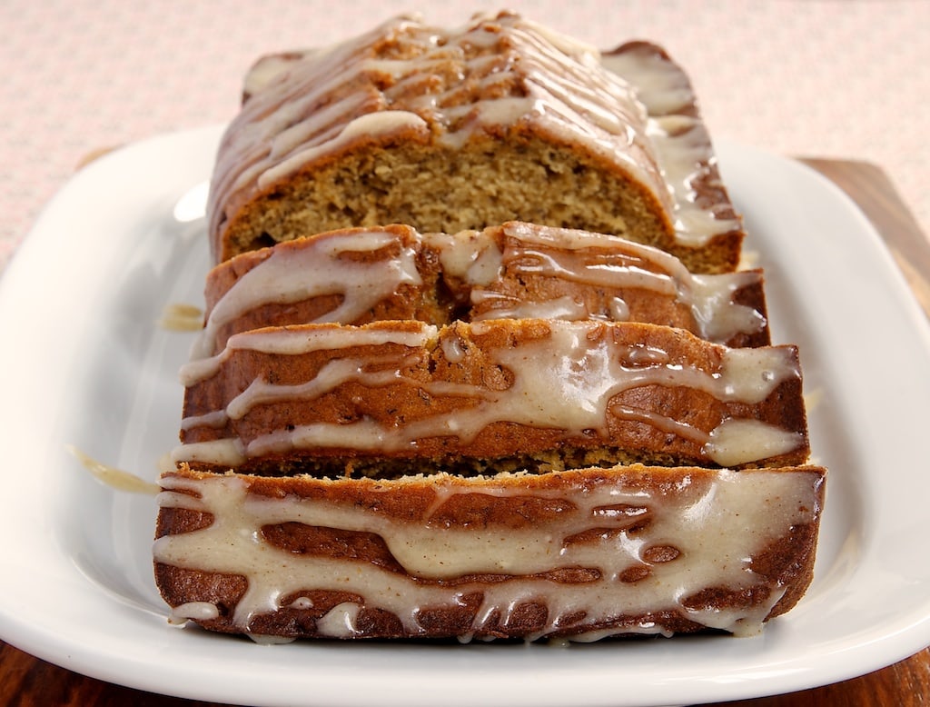 sliced Caramelized Banana Bread with Brown Butter Glaze on a white serving plate