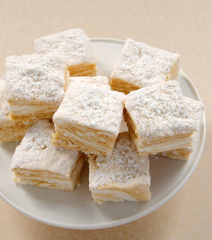 Salted Caramel Swirl Marshmallows stacked on a white pedestal