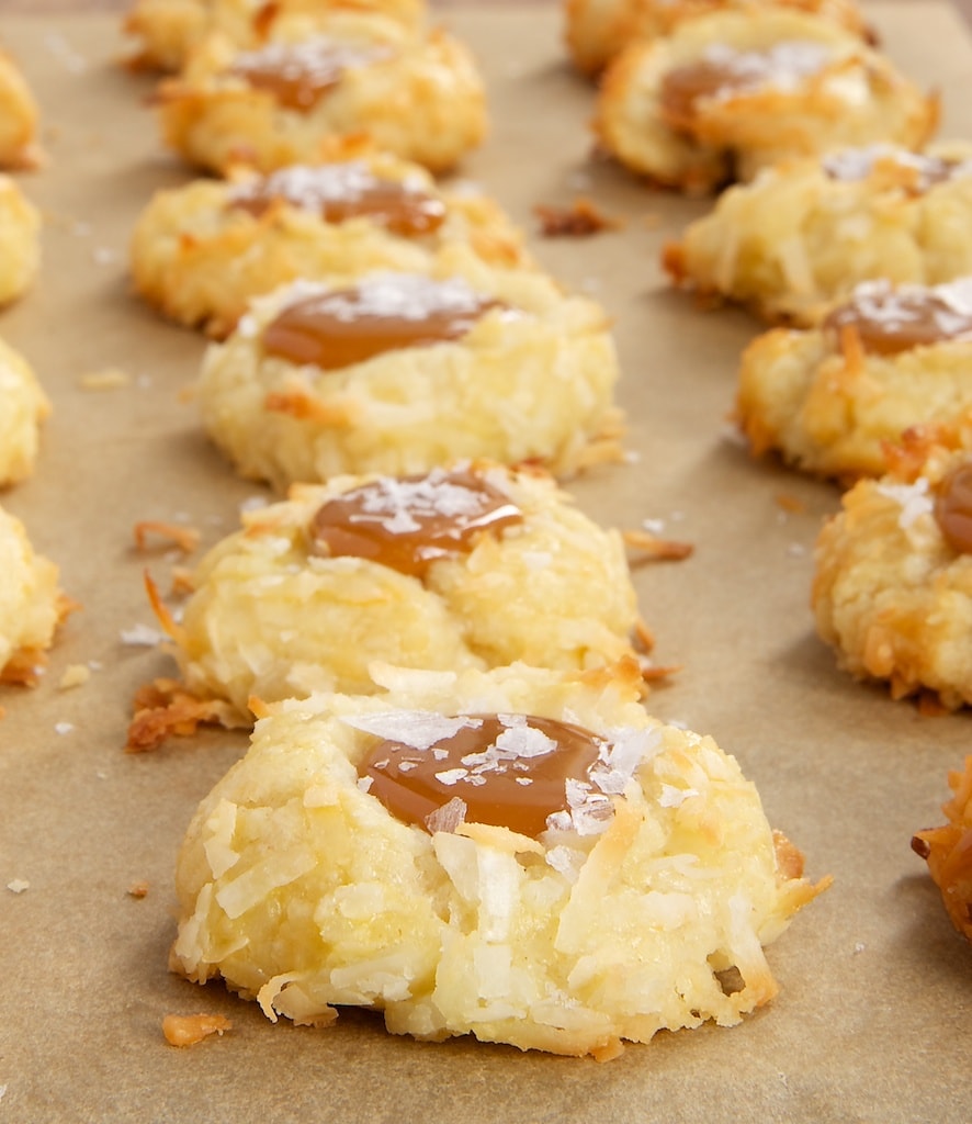 Coconut-Salted Caramel Thumbprint Cookies on parchment paper