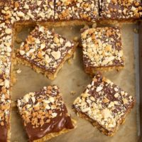 Peanut Butter-Chocolate-Oatmeal Cereal Bars on a parchment-lined baking sheet