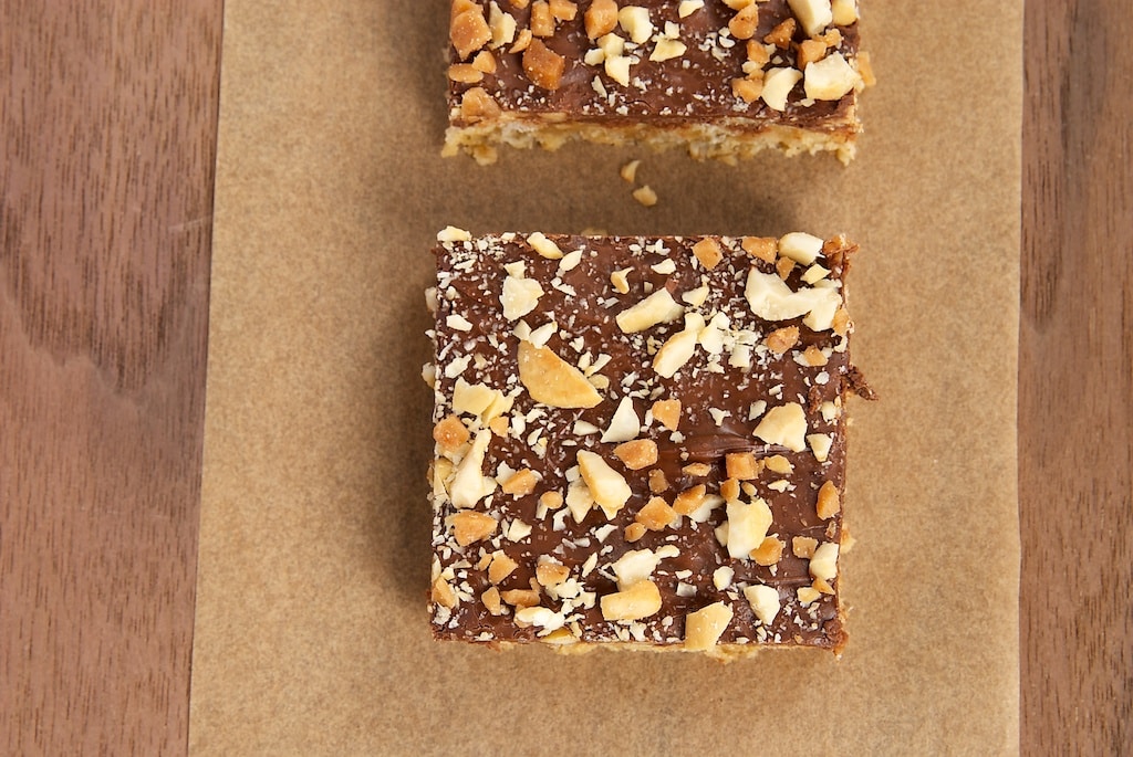 Peanut Butter, Chocolate, and Oat Cereal Bars topped with nuts