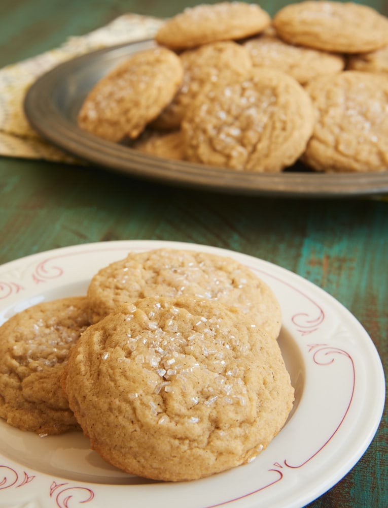 Spice cookies on a white plate with red trim.