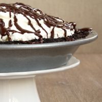 Chocolate cookie crust, hazelnuts, rich chocolate ganache, and sweetened whipped cream come together to make this delectable Chocolate Hazelnut Black-Bottom Pie. - Bake or Break