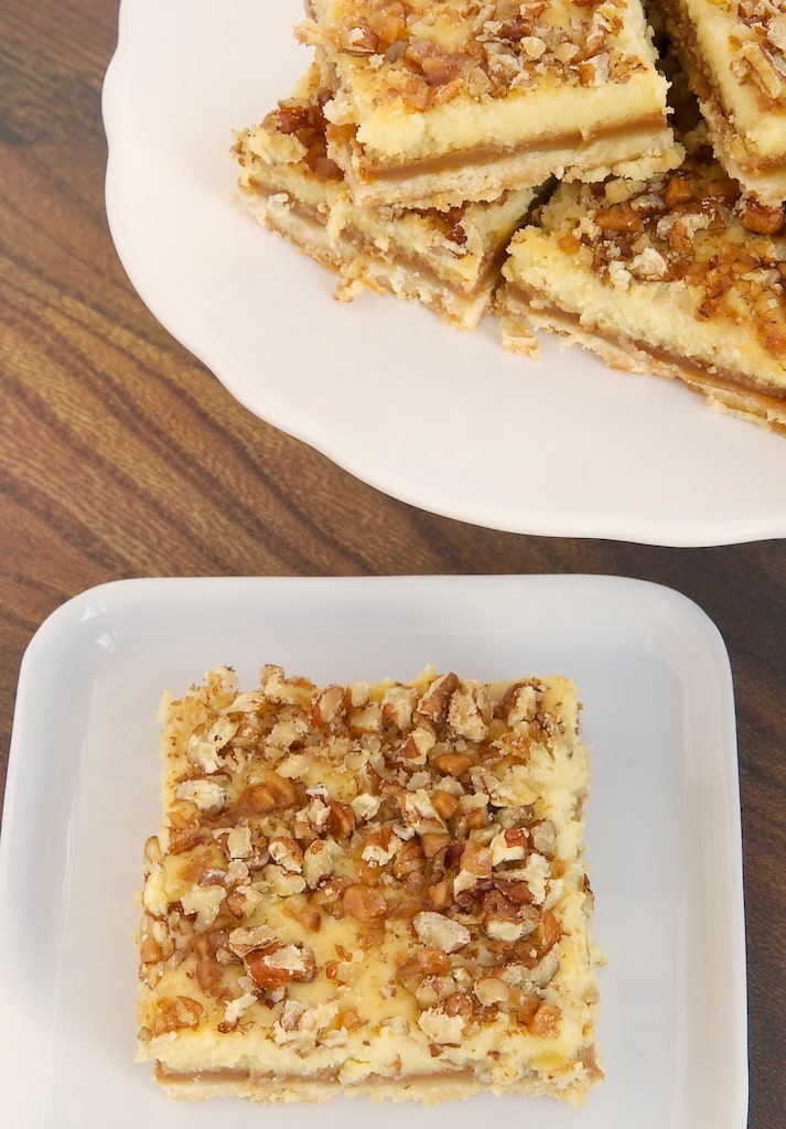 Caramel Cream Cheese Bars feature delicious layers of shortbread, caramel, cream cheese, and nuts. - Bake or Break