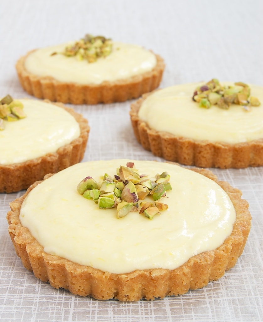 Lemon Cream Tarts on a white surface