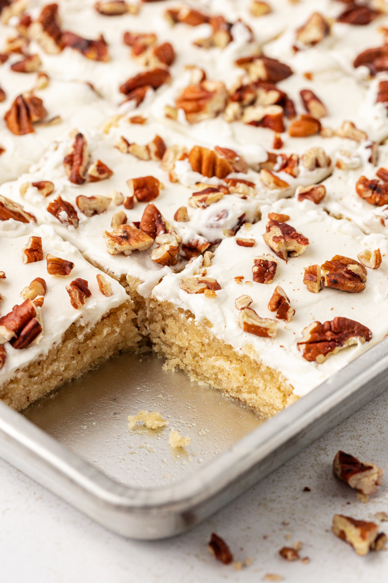 Pan of brown butter Texas sheet cake with one slice removed