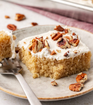 Slice of brown butter Texas sheet cake on plate with bite on fork