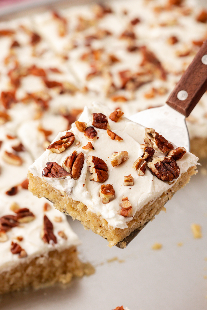 Spatula holding slice of brown butter Texas sheet cake